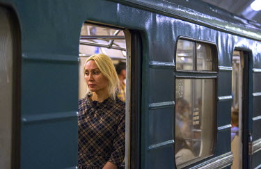 A woman deep in thought as her train pauses at Biblioteca Im Lenina (The Lenin Library) Metro Station, opened in 1935.