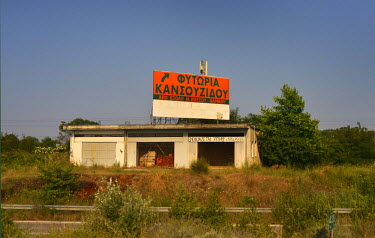 18:15hrs. A building, advertised for rent displays a billboard for club 'Utopia' to be found further up the road to Thessaloniki.
