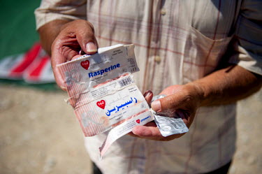 A Syrian refugee, in Mytiline, shows a box of heart medicine he takes. On the boat trip from Turkey to Greece his boat capsized and he lost his medicine. Lesbos island has become a major destination f...
