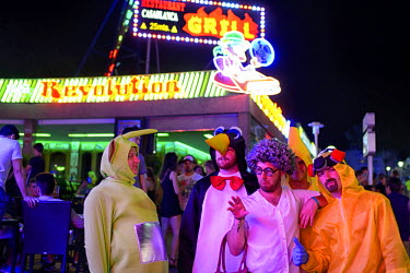 A group of men in fancy dress stand in the street outside a restaurant. Thousands of young tourists visit Magaluf each year seeking cheap alcohol and fun. The new mayor Alfonso Rodriguez, has promised...