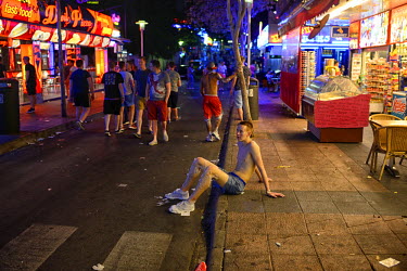 A youth, his legs covered in shaving foam, rests on the pavement. Thousands of young tourists visit Magaluf each year seeking cheap alcohol and fun. The new mayor Alfonso Rodriguez, has promised to cl...