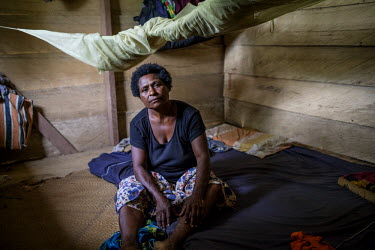 Martha Wokma, 49, in her house in Manwara village. She describes what happened when a logging company wanted to operate locally: 'My family lived in a traditional house for many years. Then the logger...