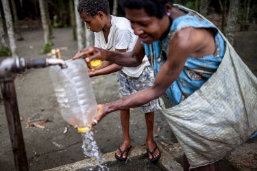 Women collect water from a public standpipe.