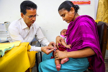 A medical worker gives an injection to Halima, three months, who has been brought by her mother Maksuda to the Dhaka Expanded Program on Immunisation (EPI) centre. The pneumococcal vaccine (PCV), whic...