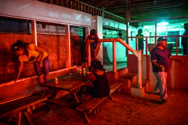 People drinking outside Gateways Public Bar in Betio, the largest township of Kiribati's capital city, South Tarawa.