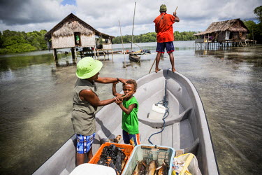 People travelling by boat from Pamachau Island to Lorengau, the capital of the Manus Province.