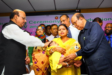 A mother and her child, dignitaries and medical staff at Dhaka Shishu (Children's) Hospital at the launch of the Expanded Program on Immunisation (EPI) where the pneumococcal vaccine (PCV), which prot...