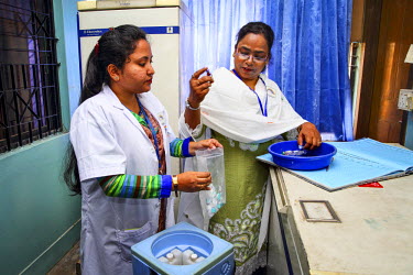 Technicians check vaccines at a hospital for use in the community as part of the Expanded Program on Immunisation (EPI) where the pneumococcal vaccine (PCV), which protects against one of the leading...