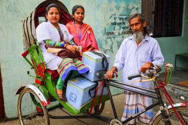 Muna, a Community Health Care Provider, transports vaccinations, kept in cool boxes, by rickshaw to the distribution point as part of the Expanded Program on Immunisation (EPI). The pneumococcal vacci...