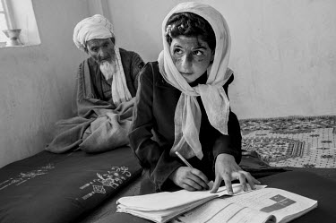 Fareeba, who set herself on fire in 2009 in order to avoid a forced-marriage, does her homework at home in Herat.