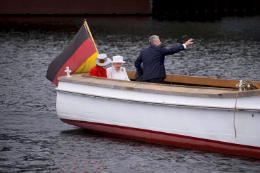 German President Joachim Gauck, his partner Daniela Schadt, Queen Elizabeth II and her husband Prince Philip, the Duke of Edinburgh (hidden), ride in a boat on the Spree River on the second day of the...
