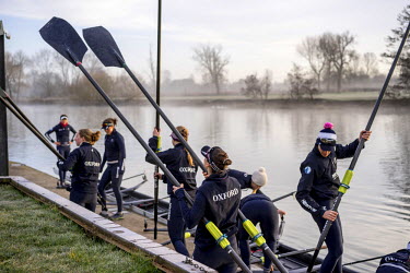 Members of the Oxford women's rowing team prepare their equipment on the shore during training on the River Thames. They are preparing for the 2015 Oxford vs Cambridge Universities Boat Race which for...