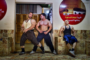 Gazan body builders strike poses after a workout.