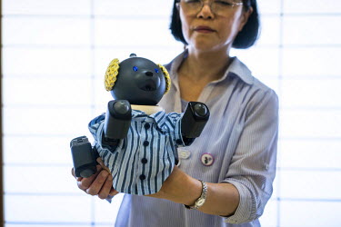 Fumiyo Kawara, 65, poses with her AIBO at an AIBO meeting outside of Tokyo. In 1999, Sony released a series of robotic pets called AIBO or Artificial Intelligence Robot. In 2006, they discontinued the...