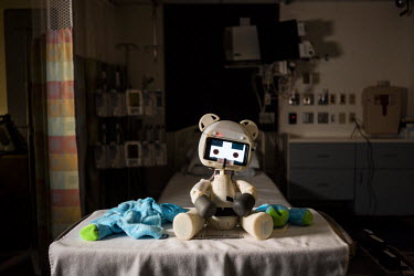 The Huggable Bear, a social robotic stereotype, sits on a table at Boston's Children Hospital next to it's remote control station. Huggable is being used in an experiment between Boston's Children Hos...