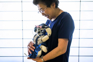 Sumie Maekawa, 73, holds her AIBO at an AIBO gathering in Tokyo. In 1999, Sony released a series of robotic pets called AIBO or Artificial Intelligence Robot. In 2006, they discontinued the AIBO line...