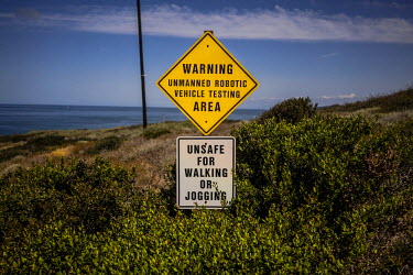 A sign warns of unmanned vehicle testing at Spawar, or Space and Naval Warfare Systems Command, a research and operations arm of the Navy. An autonomous vehicle named RaDer is being tested here. The U...