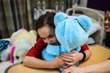 8-year old Beatrice Lipp hugs the Huggable robotic teddy bear in an hospital room at Boston Children's Hospital. Beatrice has been in and out of Hospitals for the last 5 years. Now at Boston Children'...