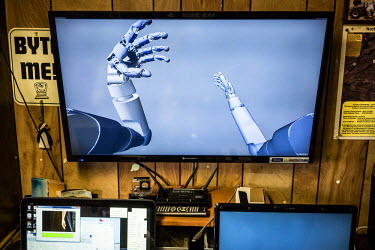 A screen shows the Virtual Reality system that Les Baugh has at home with which he practices mind control techniques for using the experiemental prosthetic arms being developed by John Hopkins Applied...