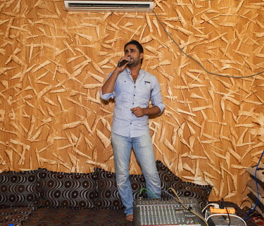 Jandi used to perform with a band in Syria. Now he has replicated his role at the Domiz Refugee Camp, where he is known as 'the wedding singer'.