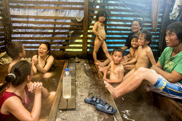 A group of women and children take a hot stone bath with spring water, which is believed to heal bone ailments. According to legend a vulture with a broken wing dipped the injured wing into the water...