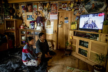 Lhakpa and his daughter, Tshering Yangchen, watch TV in their house in Phobjikha Valley. Internet and TV arrived in Bhutan in 1999 and the state owned BBS TV remains the only television channel.