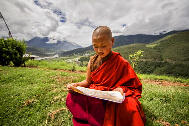 A young nun studies at the Sangchen Dorji Lhendrup Nunnery. Bhutan's culture is rooted in Buddhism, which emphasises the interdependence between humans and nature.