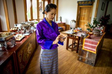 Dawa Dem checks her mobile phone. She runs a hotel in Paro, having studied hospitality in Thailand. Tourism is on the rise in Bhutan and is the second largest source of income after hydroelectric powe...