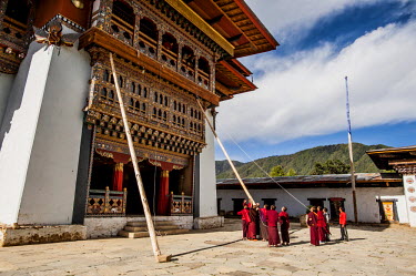 Monks erect supports to carry out maintenance work at Gangtey Goempa Monastery.