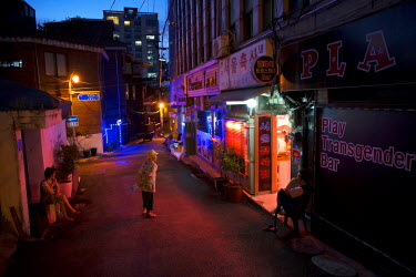 Residents loiter outside in a street lined with gay and transgender bars near Usadan-ro No. 10 in the Itaewon and Hannan neighbourhoods.