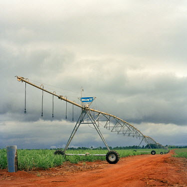 A mobile irrigation system lines fields and a road running through land cleared by Addax Bioenergy to produce sugarcane and biofuel for export to the European Union.
