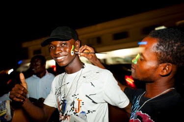 A man has his face painted with the national colours on Oxford Street, a popular entertainment precinct in Accra after Ghana defeated the USA on 26 June 2010 during the 2010 FIFA World Cup.