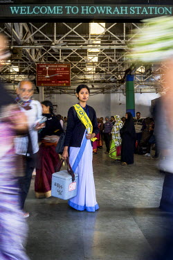 19 year old, Seema Puria, a nursing student from the Howrah District Hospital, with her medicines and wearing a Polio Day sash, at the Howrah Station. Seema, along with other nursing students vaccinat...