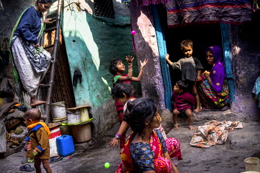 On Polio Day young children play with the colourful plastic balls they were each given after taking their oral polio vaccinations at the Muslim Camp Basti in Dhabiatalab. On Polio Days, small booths a...