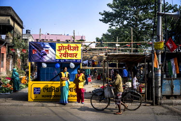 Vaccinators wait for children at a polio booth outside a market in Panchanatala Bazaar on Polio Day in Kolkata. On Polio Days, small booths are set up in different parts of the city, urging local resi...