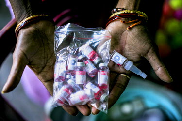 A vaccinator shows a bag full of polio vaccine vials on the Polio Day at the Muslim Camp Basti in Dhabiatalab. On Polio Days, small booths are set up in different parts of the city, urging local resid...