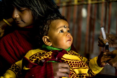 An infant gets his finger marked after receiving his oral vaccination at a polio booth on Polio Day at a municipal office in Kolkata. On Polio Days, small booths are set up in different parts of the c...
