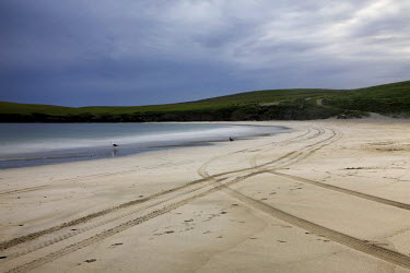 Tyre tracks mark the beach at St Ninian's Isle, Shetland.