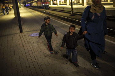 Refugees, mainly from Syria and Afghanistan, make their way a long a platform to board a train at Vienna's Westbahnhof bound for Munich.  Hungary, along with Italy and Greece, has seen a huge influx o...