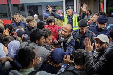 A large crowd of refugees and migrants is seen in the Austrian village of Nickelsdorf where they have gathered after crossing the border from Hungary. They are waiting to get trains to Vienna and poss...