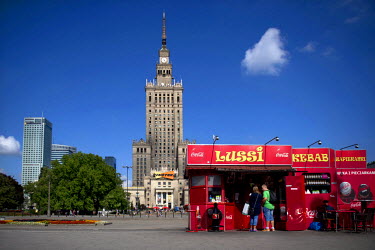 Fast food stalls, advertising Coca-Cola and the Soviet era Palace of Culture and Science, designed by Lev Rudnev.