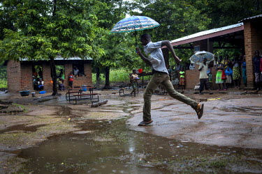 A man runs through the rain at Mchere school which has been converted into a temporary IDP camp for people affected by flooding that forced around 250,000 people from their home sin early 2015.