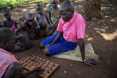 Rosemary Aneno, 15 years old, plays a game called Omweso (Bao) at primary school where she is in the final year and also a member of the health club. Her mother is dead and her older brother supports...