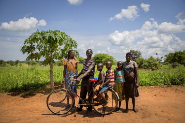 Nasa Oyoo Otii, 47 years old, with his wife Margaret Alanyo, 41 years old and four of their six children. In 2000 Nasa fled Lord's Resistance Army insurgency with his wife and children to become IDPs...