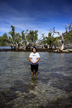 Gildreth Abanci during low tide in the mangroves on the island of Igbon. She says: 'My husband helped build the breakwater and I helped replant the mangroves. We have learned from Haiyan to be better...