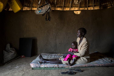 Debora Adum, 30 years old, and daughter Nyibol Ajak, 18 months old in their shelter in Mongula displaced South Sudanese settlement. Debora and her four children fled from the village of Palieu in Jong...