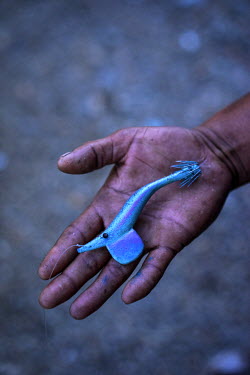 41 year old Roy Ascura shows a lure for squid jigging at his house on Polopina island. The island was badly hit by Typhoon Haiyan. Roy says: ‘I learned I would get a boat from Concern and was so hap...