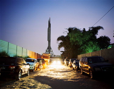 A view down a dirt track toward the mausoleum of Agostinho Neto (1922 - 1979), the first president of Angola. The structure is known as 'Sputnik' to locals. It took almost 12 years to built and was fi...
