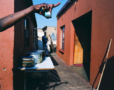 Preparations take place in a courtyard in the poor residential area of Vosloorus in southwest Johannesburg. The people are celebrating the election of one of the residents to the municipal council.