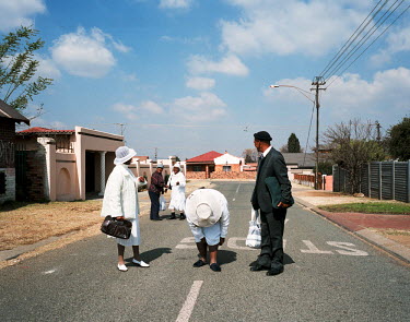 Two women and a man make their way to Sunday Mass in Coloured community in Soweto. an ethnic label for people from mixed ethnic background that make up around 9% of the population of South Africa. ^As...